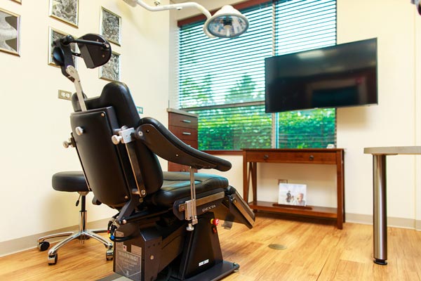 Dental chair in exam room at Wheaton Oral Surgery in Naperville, IL