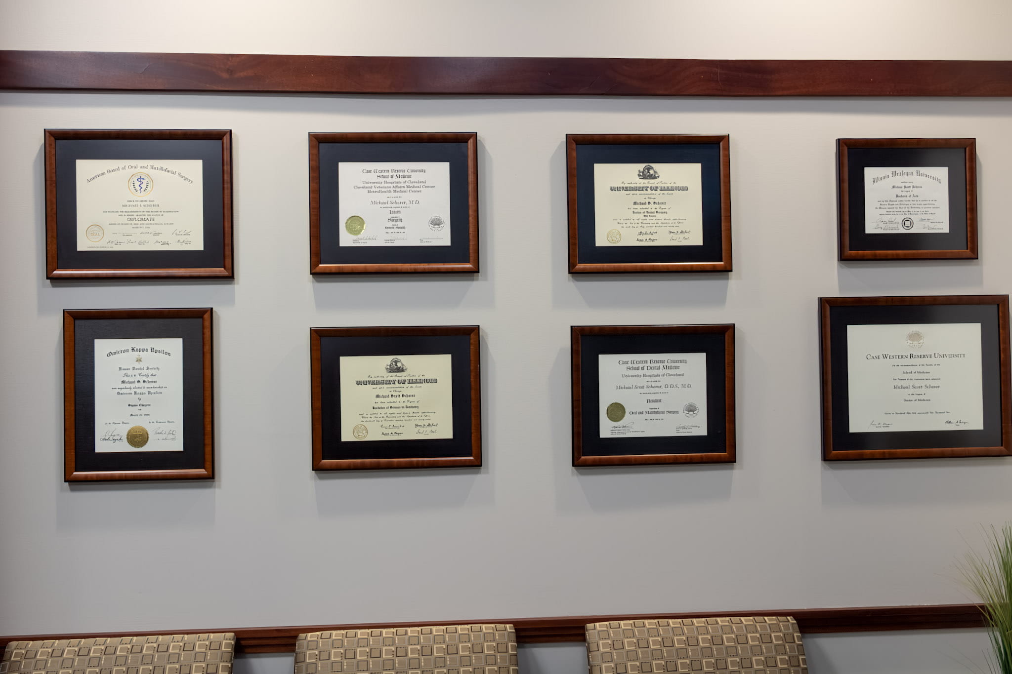 Dr. Scherer framed degrees on wall at Wheaton Oral Surgery in Naperville, IL