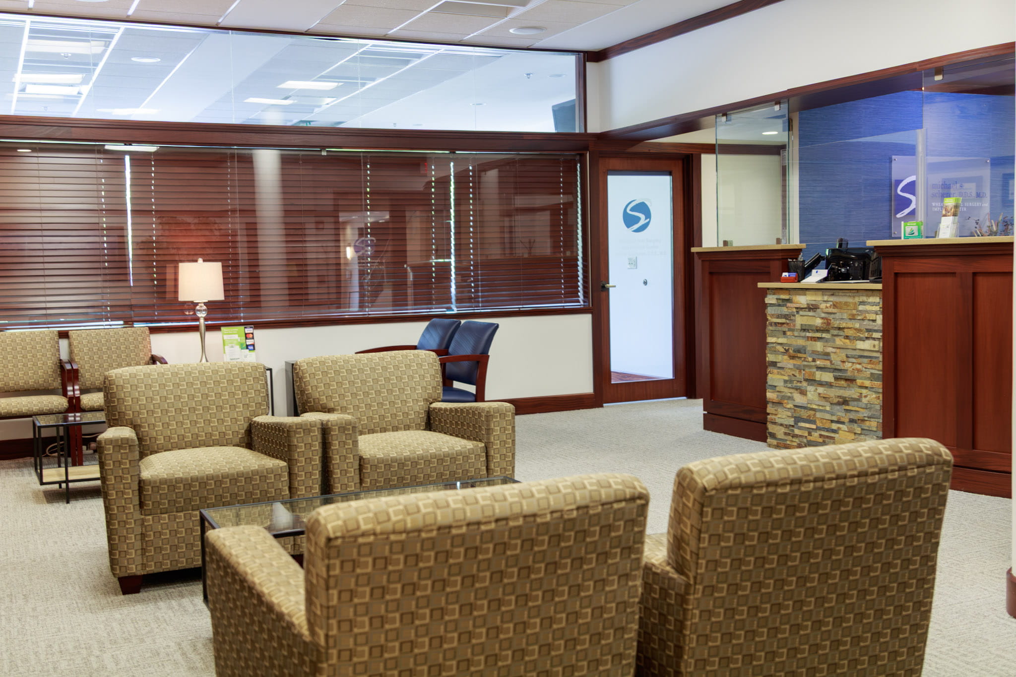 Office room with chairs and TV at Wheaton Oral Surgery in Naperville, IL