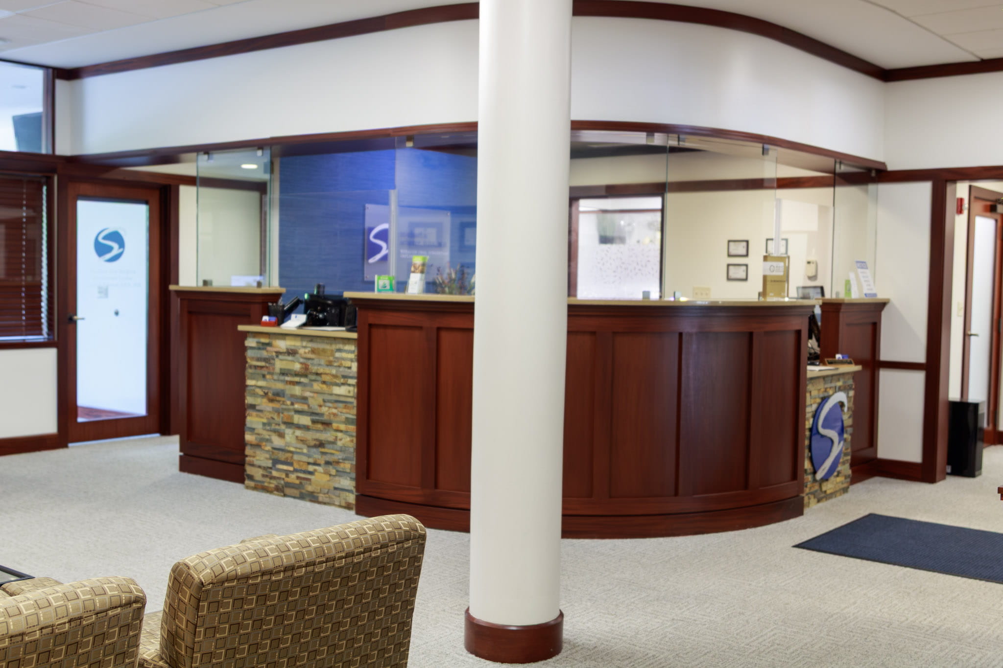 Hallways with framed photos on walls at Wheaton Oral Surgery in Naperville, IL