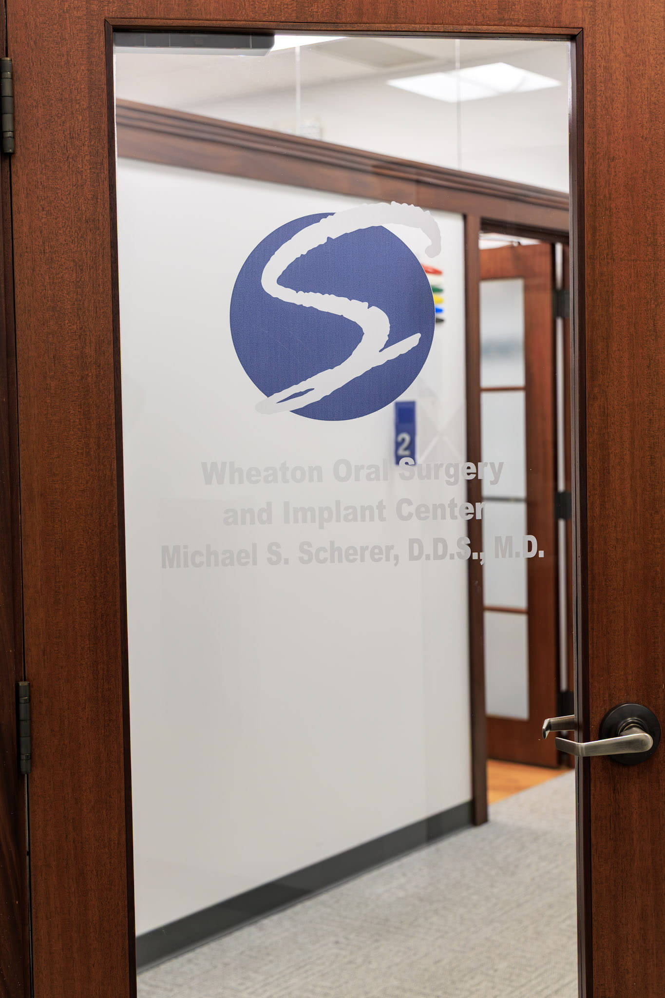 Desk area with mission statement on wall at Wheaton Oral Surgery in Naperville, IL