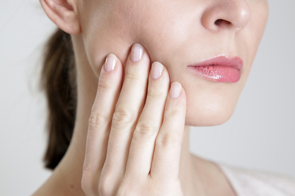 Close up of a woman with facial pain